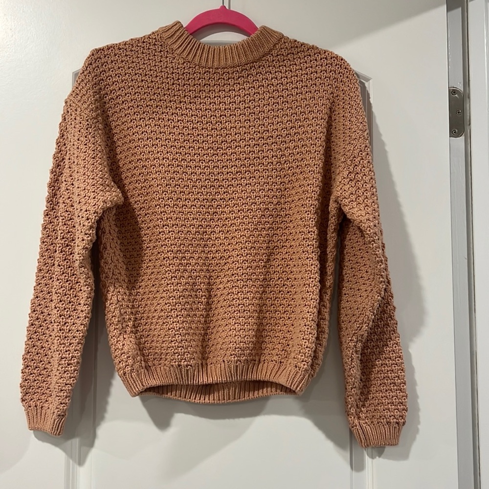 Universal Tread cable knit sweater. Muted pink color